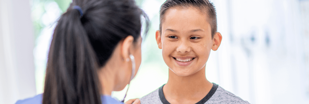 1200x406_female doctor with young boy patient female doctor with young boy patient
