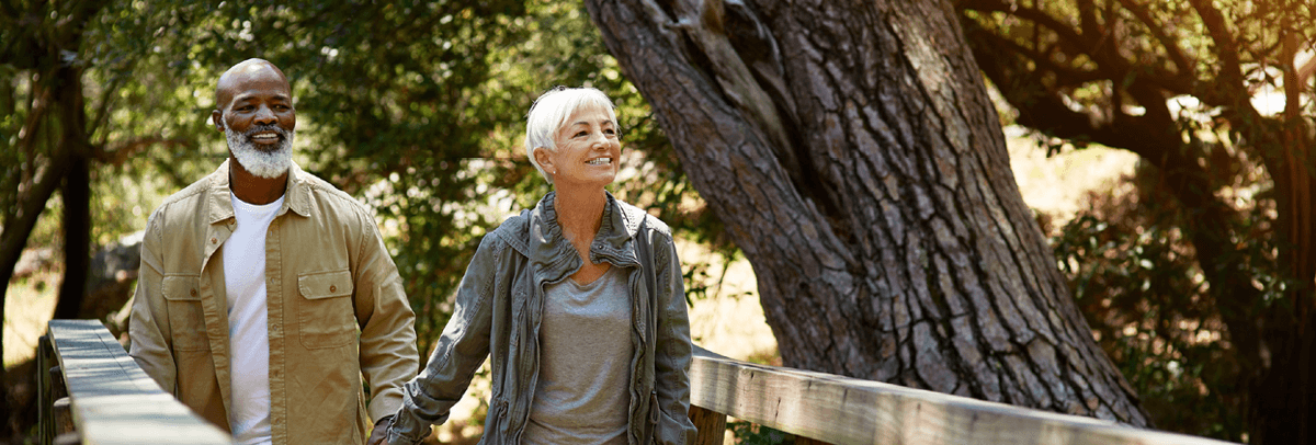 1200x406_couple walking senior couple walking in nature